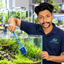 Gokul in Aquatic Vision uniform maintaining a planted aquarium