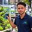 Samir in Aquatic Vision uniform maintaining a planted aquarium
